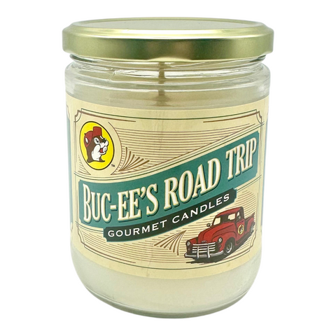 Buc-ee's glass candle with vintage red truck illustration and turquoise label